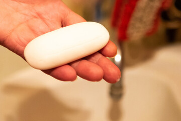 Woman washes her hands with soap under a stream of water. Covid19 concept