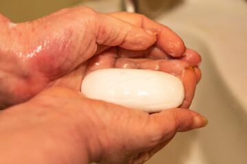 Woman washes her hands with soap under a stream of water. Covid19 concept