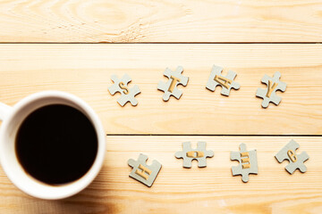 Few mockup puzzles and coffee cup on wooden background. Stay at home concept