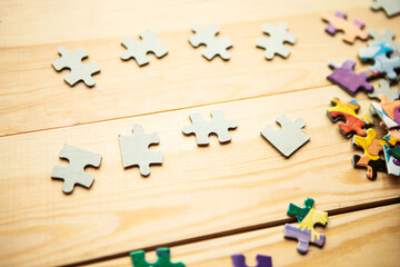 Few mockup puzzles on wooden background. Stay at home concept