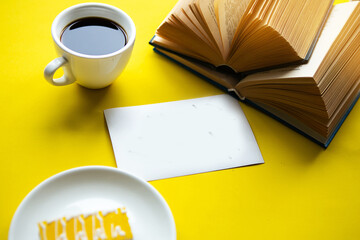 Quarantine concept - flatlay photo with coffee cup, cake, books  and the card with the text Stay Home