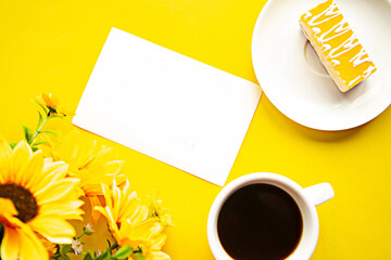 Quarantine concept - flat lay photo with coffee cup, cake and card with message Stay Home on bright yellow background.