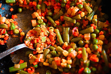 Delicious fried vegetables in a pan, closeup