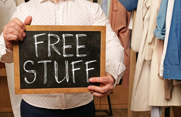 Free stuff, message on a board hold by businessman
