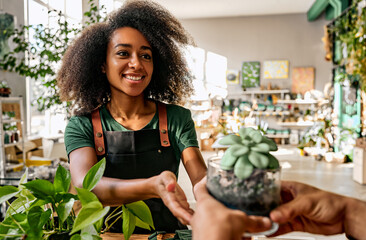 A beautiful African-American florist, a small business owner, is taking orders to sell succulents,...