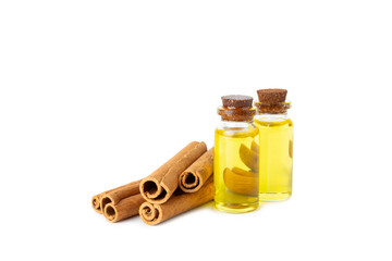 Cinnamon aromatic essential oil and cinnamon sticks isolated on white background. Aromatherapy. Organic cosmetic oil. Spa concept.