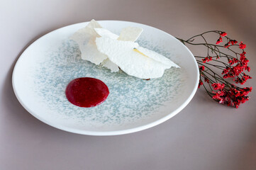 Elegant vegetable pâté with vibrant beetroot coulis and fresh herbs, plated artistically....