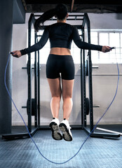 Woman, skipping and gym for cardio fitness, endurance and exercise in wellness. Workout, sport or...