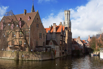 Rozenhoedkaai, (Rosary Quay), Bruges, Belgium: the Belfry Tower dominates the medieval gabled canalside buildings in this classic view of Bruges.