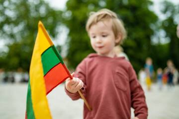 Cute boy holding tricolor Lithuanian flag on Lithuanian Statehood Day, Vilnius, Lithuania - 793869788