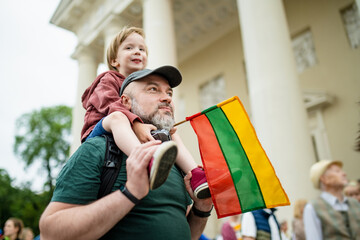 Cute little boy and his father holding tricolor Lithuanian flag celebrating Lithuanian Statehood Day in Vilnius - 793869923