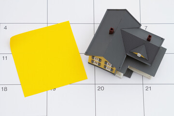 Mortgage payment due with house and sticky note on a calendar