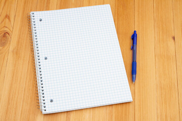 Retro old lined graph paper notepad and pen on a desk
