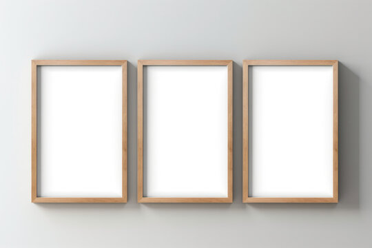 Three empty wooden frames hanging on wall