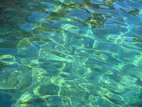 Transparent sea water with pebbles at the bottom.