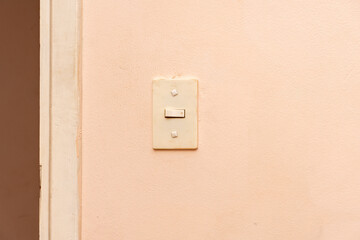 Old light switch on an old wall. - obrazy, fototapety, plakaty