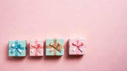 Gifts on pastel pink background. Four small color square 3D paper boxes tied with satin ribbons. Pleasant surprise. Flat lay holiday background. Birthday or christmas present. Copy space.