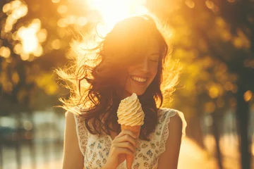 Foto auf Alu-Dibond Girl holding ice cream in a waffle cone in street, sunlight in her hair. © 7707601