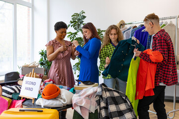 second-hand store, saving money and family budget, young people students at swap party try on...