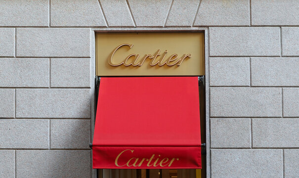 MILAN, ITALY &ndash; APRIL 11, 2024: Red marquise with golden logo in Via Monte Napoleone. Cartier is a French luxury jewelry and world famous watch brand