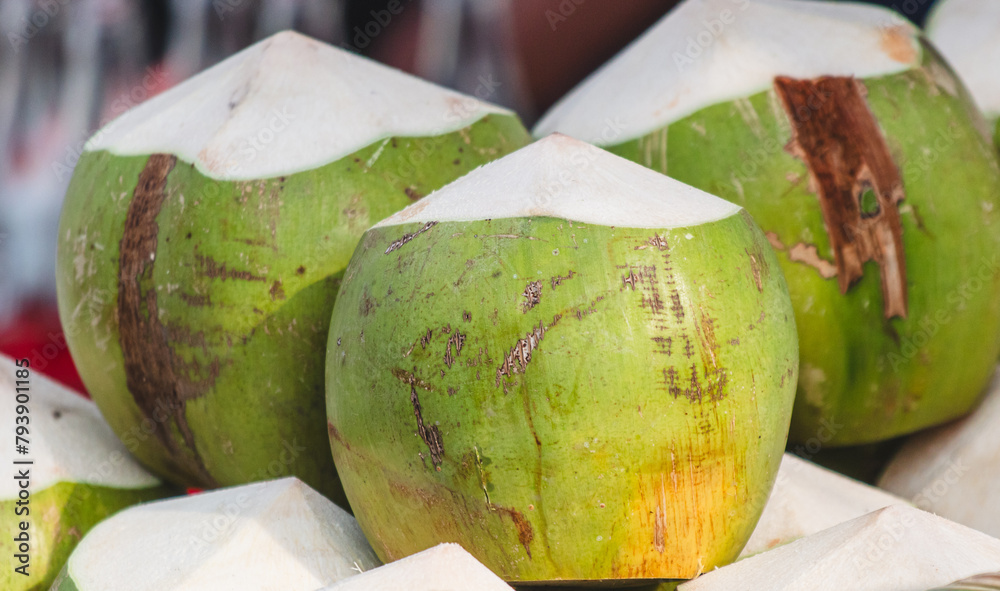 Wall mural Harvest of green coconut nuts as background