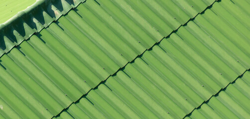 Old green metal roof as an abstract background. Texture