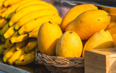 Yellow mango on a counter in a market - 793901197