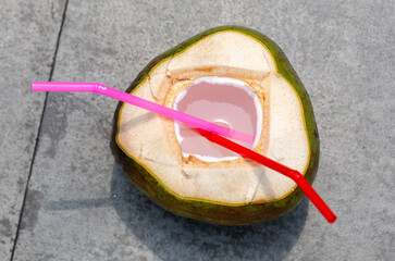 Coconut with a straw on the road - 793901585