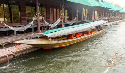 Fototapeta na wymiar A boat floats on the River Kwai in Thailand