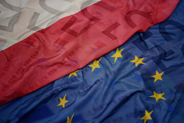 waving colorful flag of european union and national flag of poland.finance concept.
