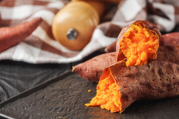 baked sweet potatoes on a dark wooden rustic background