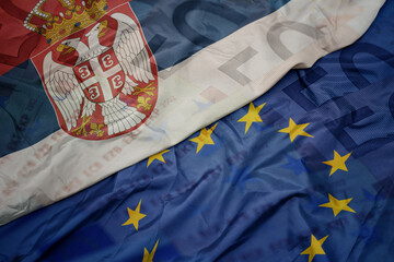 waving colorful flag of european union and national flag of serbia.finance concept.
