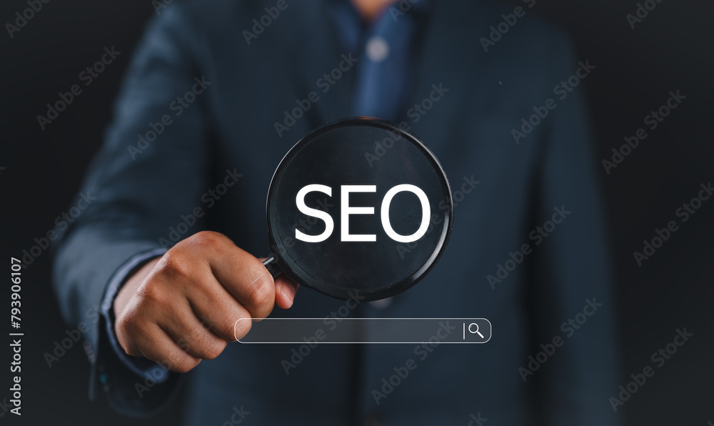 Poster Businessman using magnifying glass focus to SEO icon to analyze SEO search engine optimization for promoting ranking traffic on website and optimizing your website to rank in search engines.