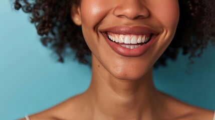 A close-up of a smiling woman with plump lips after cosmetic lip augmentation surgery, radiating confidence and beauty. - obrazy, fototapety, plakaty