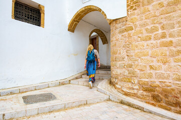 Occidental blonde girl in Kasbah of Udayas fortress in Rabat Morocco. Kasbah Udayas is ancient...