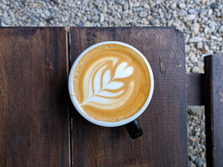 close up glass of coffee on a wooden table in a cafe