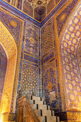 Ornate golden-blue minbar of Madrasa Tilya Kori, Registan, Islamic art and architecture. Arabic...
