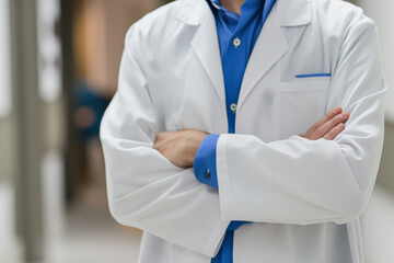 Professional healthcare provider stands confidently with crossed arms, stethoscope visible