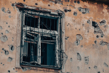 empty windows of a damaged house in Ukraine
