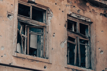 Fototapeta na wymiar empty windows of a damaged house in Ukraine