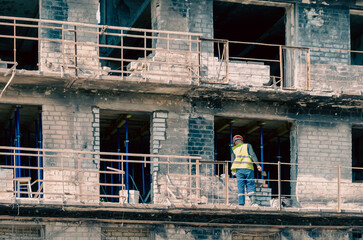builder at work on the restoration and repair of destroyed houses in the city of Ukraine