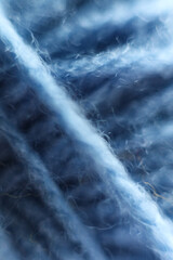 Macro shot of a blue wool yarn background. Soft focus.