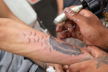 close up of a tattooist in action