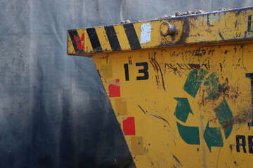 Fototapeta premium Industrial garbage container for construction sites. Metal container for recyclable garbage. Recycling industry. Industrial waste management.
