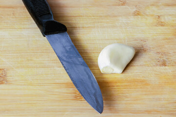 Knife with garlic on a cutting board