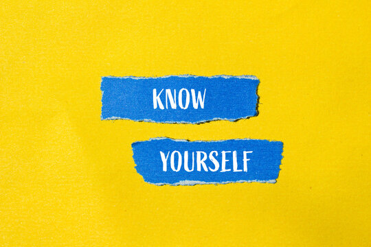 Know yourself words written on ripped blue paper pieces with yellow background. Conceptual know yourself symbol. Copy space.