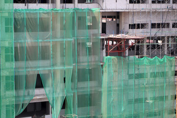 High-rise buildings under construction have coverings to prevent debris from spreading outside the...