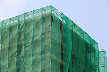High-rise buildings under construction have coverings to prevent debris from spreading outside the...