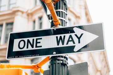 One way sign on the side of the street in Manhattan - New York City. - obrazy, fototapety, plakaty