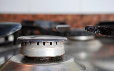 Close up iron stainless steel counter top stove with off position and no flame isolated on horizontal ratio background. Kitchen equipment photography.